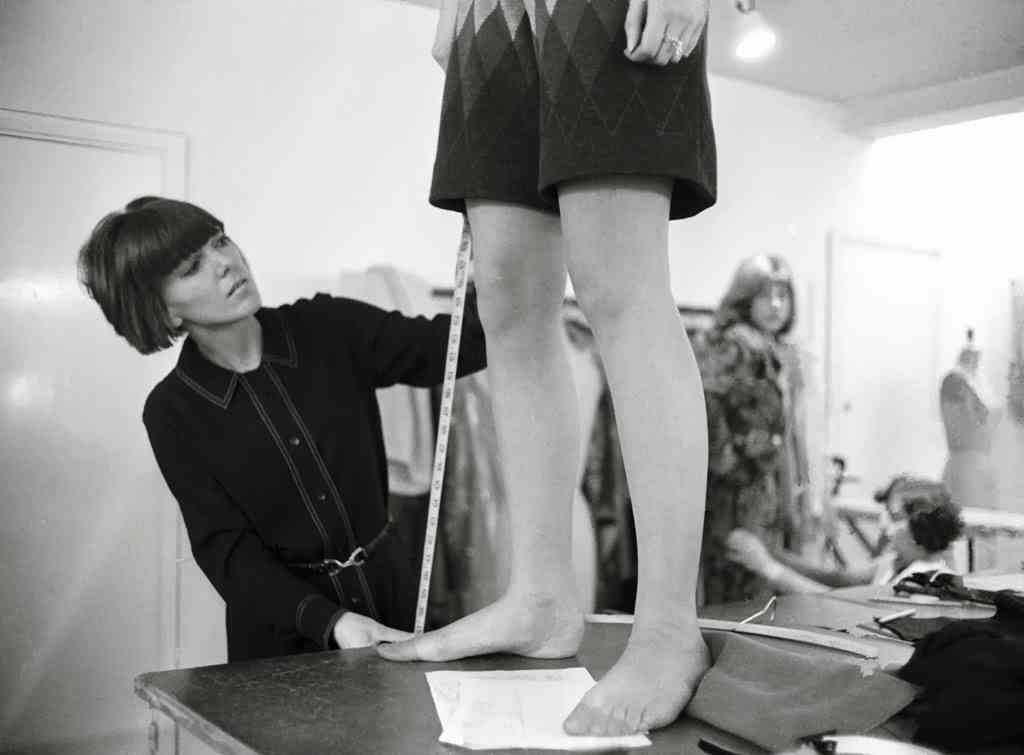 Mary Quant the fashion designer in her lab in Chelsea measuring the length of a mini skirt:  Year 1965